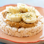 Rice cake with peanut butter and banana on a plate